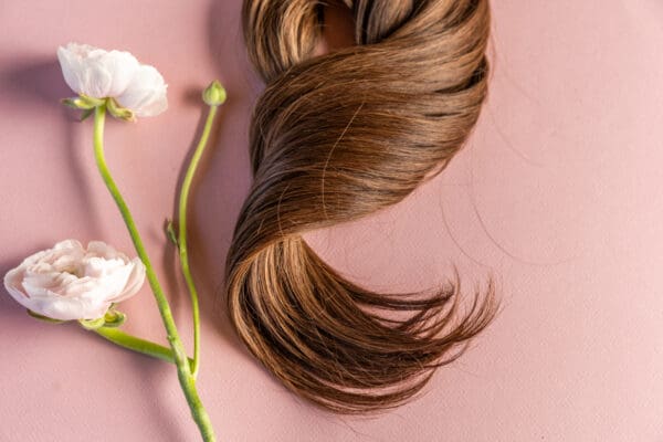 A close up of a hair brush and some flowers