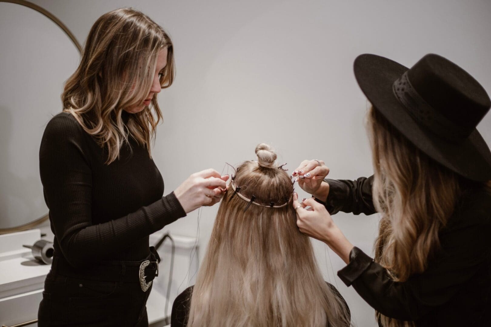 A woman is getting her hair cut by another person.
