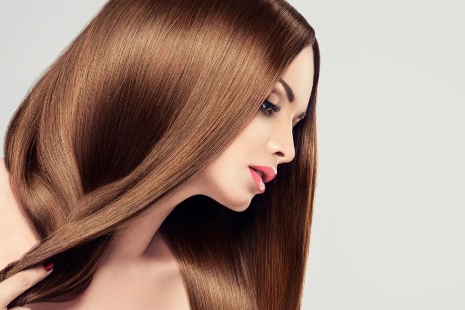 Hair Haven Extension Academy A woman with long brown hair is looking at the camera.