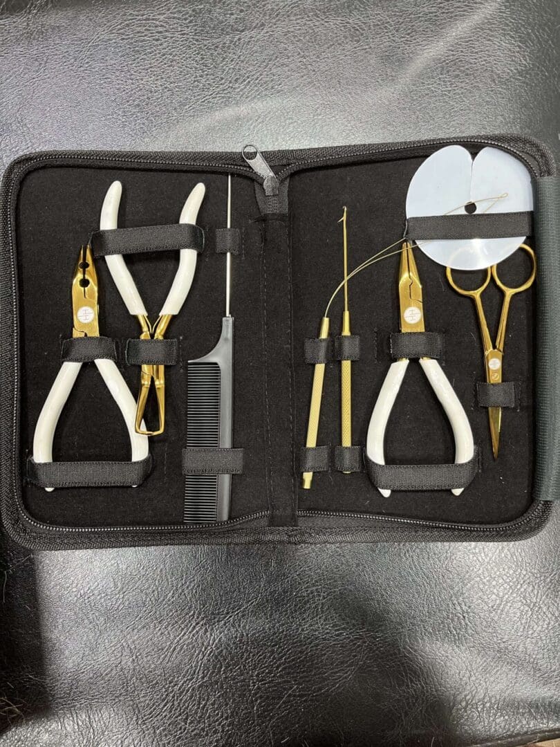 A set of scissors and tools in a case.
